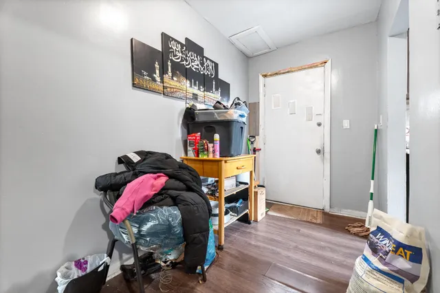a kitchen with a refrigerator and white cabinets