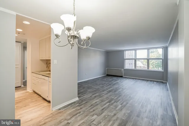 a view of a room with wooden floor and windows