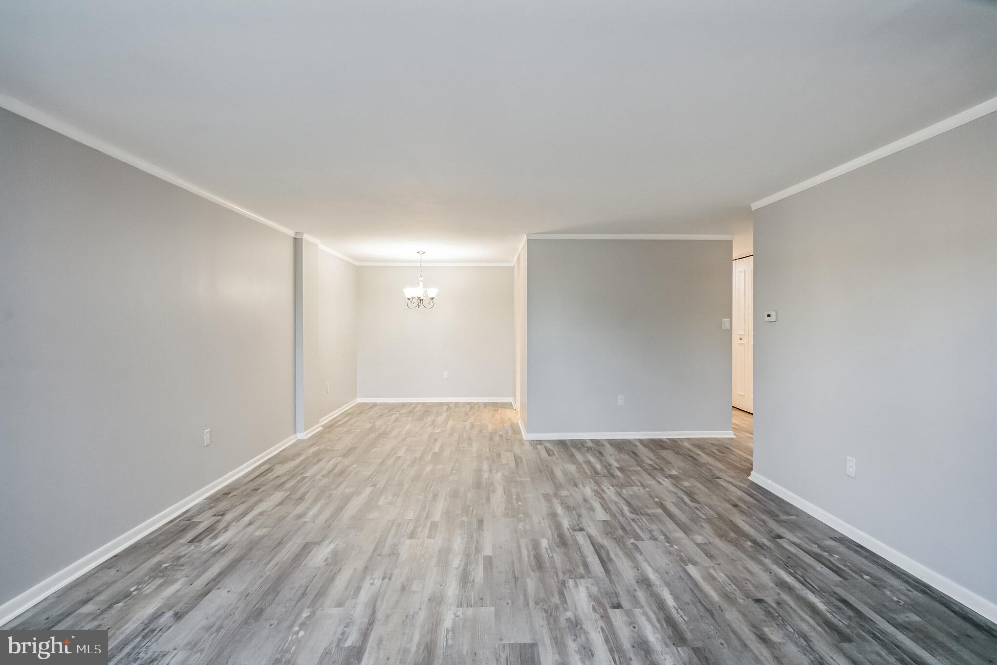 6100 Henry Avenue, Unit 4I Philadelphia, PA 19128 - Photo 13 of 30 a view of an empty room with wooden floor
