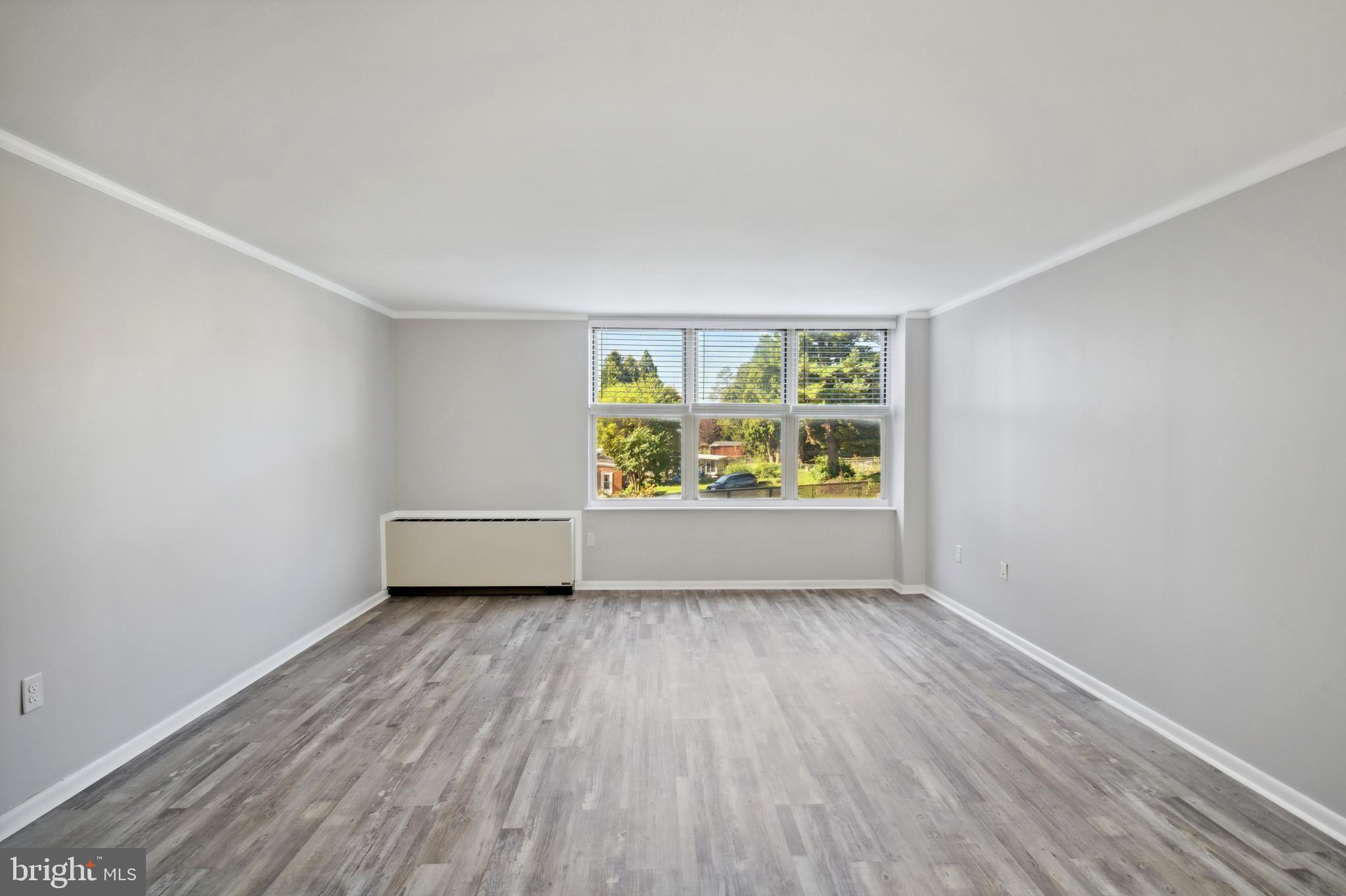 6100 Henry Avenue, Unit 4I Philadelphia, PA 19128 - Photo 14 of 30 an empty room with wooden floor and window