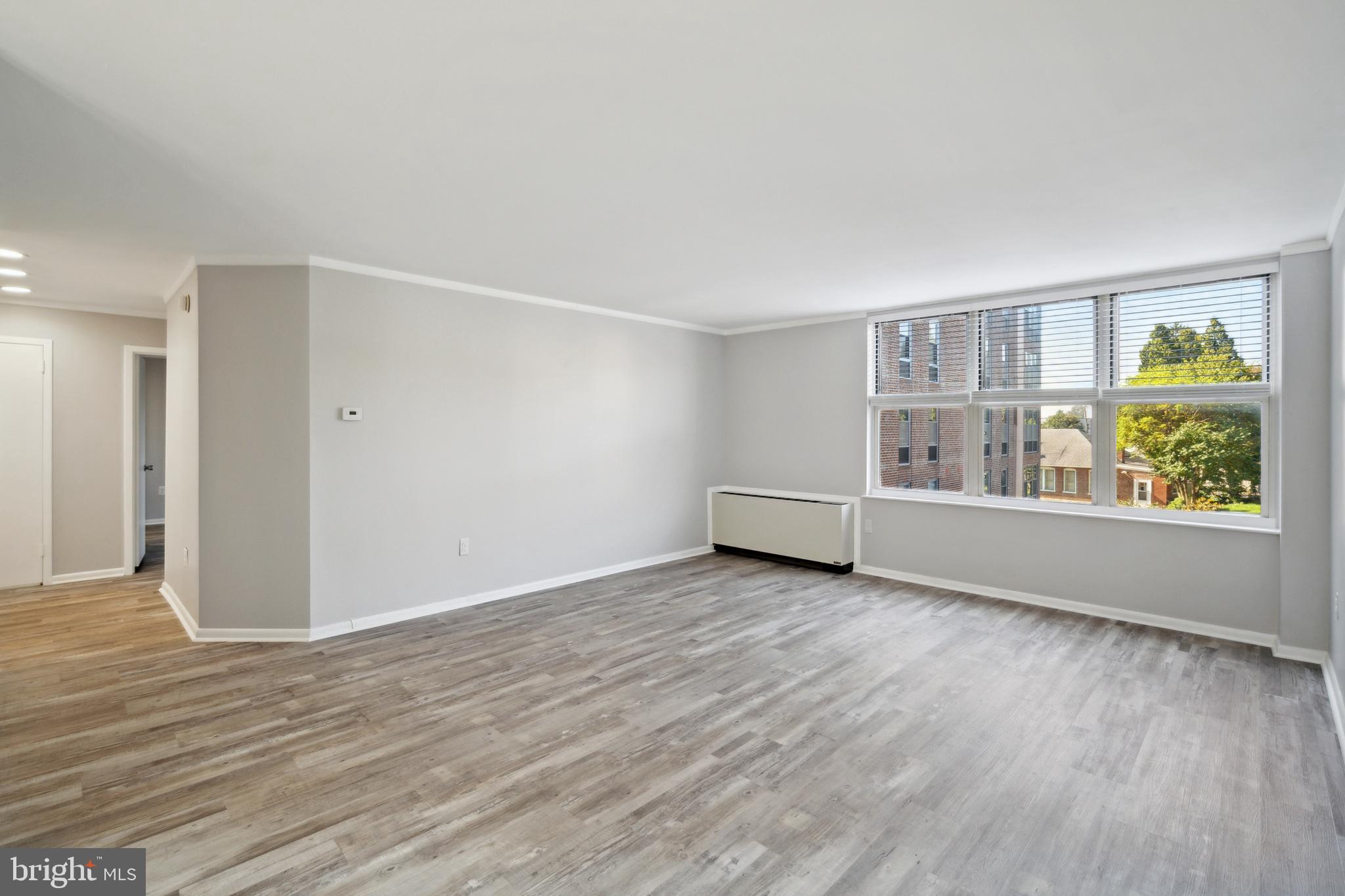 6100 Henry Avenue, Unit 4I Philadelphia, PA 19128 - Photo 15 of 30 a view of an empty room with window and wooden floor