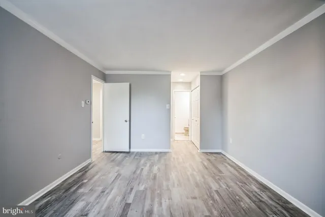 a view of a room with wooden floor
