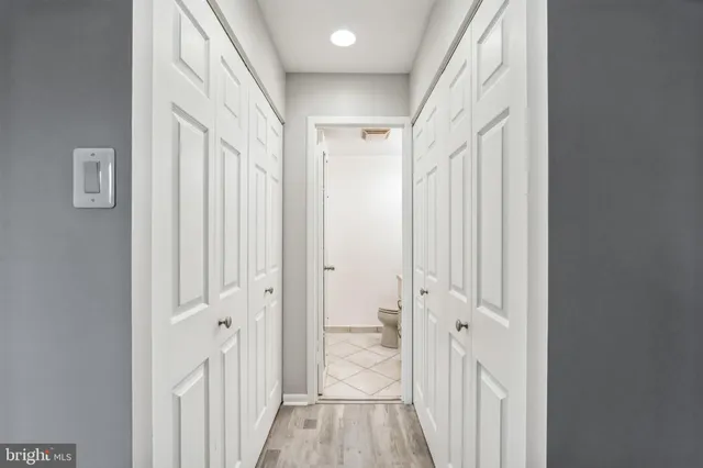 a view of a hallway with a wooden door