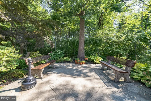 a backyard of a house with chairs and a fire pit