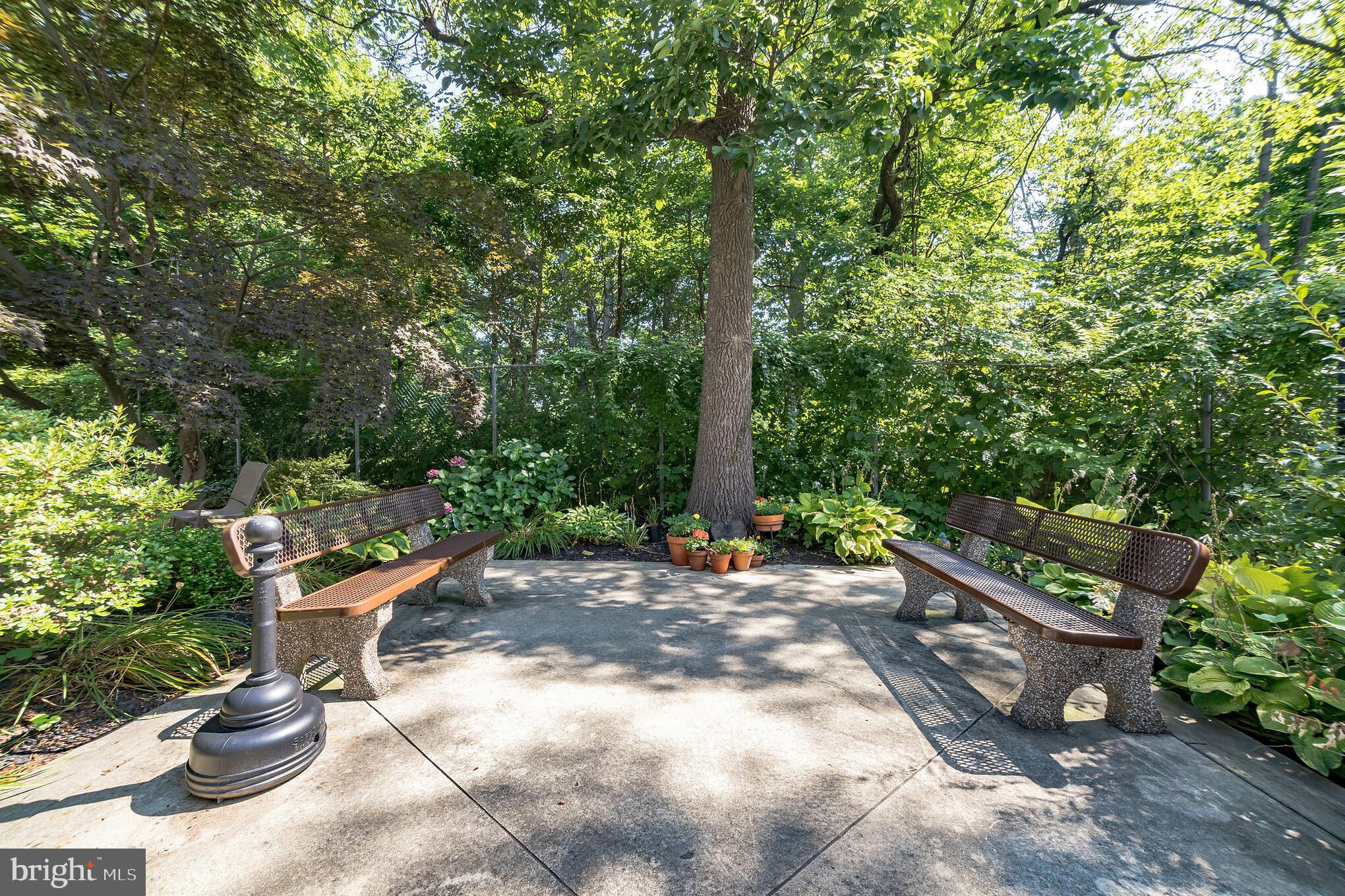 6100 Henry Avenue, Unit 4I Philadelphia, PA 19128 - Photo 24 of 30 a backyard of a house with chairs and a fire pit