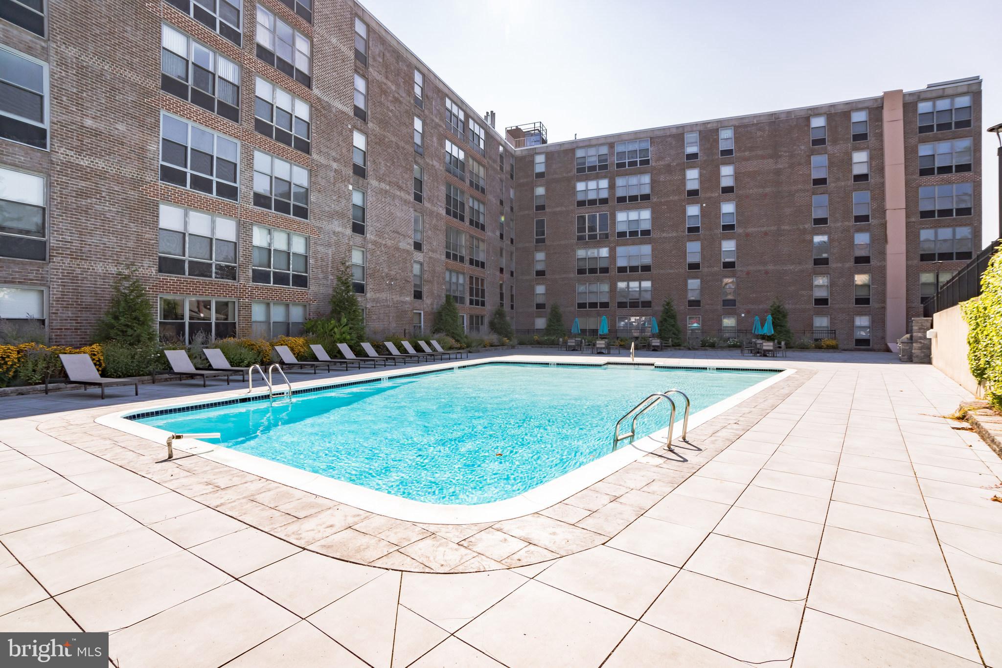 6100 Henry Avenue, Unit 4I Philadelphia, PA 19128 - Photo 26 of 30 a view of a swimming pool with a lounge chairs