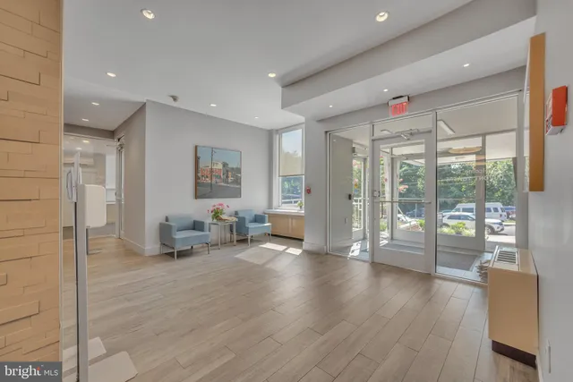 a hallway with wooden floor and furniture