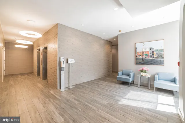 a view of a livingroom with wooden floor and furniture