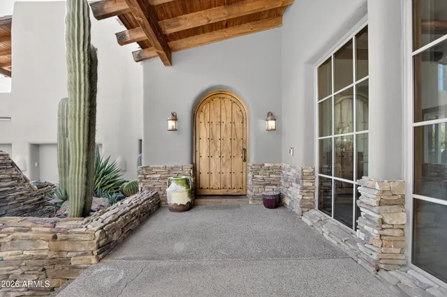 a kitchen with granite countertop wood cabinets stainless steel appliances and a wooden floor