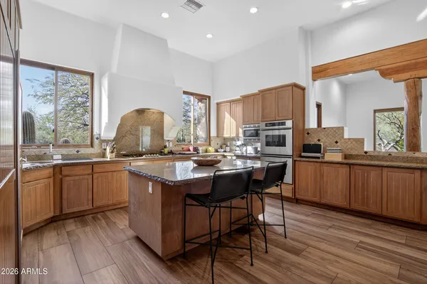 a kitchen with sink a stove and cabinets