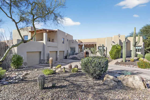 a front view of a house with garden and patio