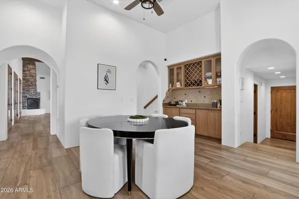 a bathroom with a double vanity sink and mirror with bathtub