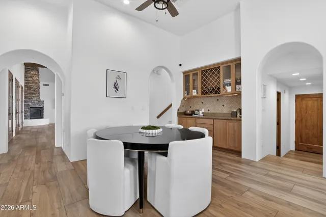 a bathroom with a double vanity sink and mirror with bathtub