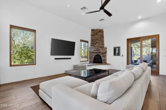 a view of a workspace with furniture and a window