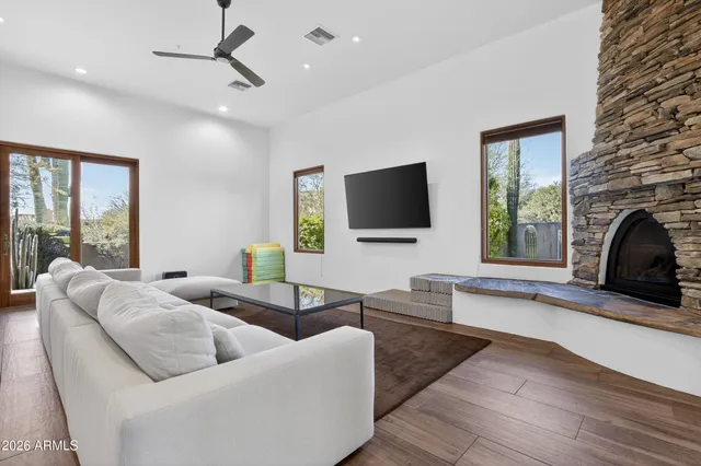 a bathroom with a granite countertop double vanity sink and a mirror