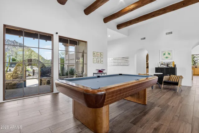 a bedroom with a bed and a flat tv screen on dresser