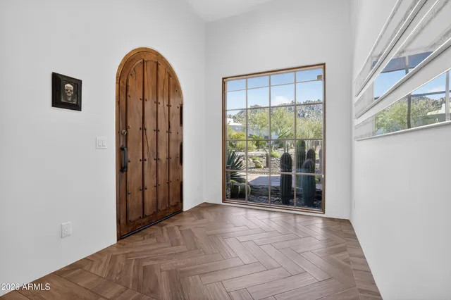 a living room with a baby crib furniture and a window