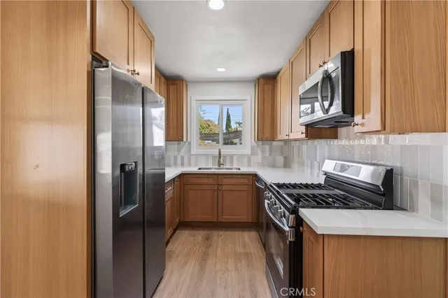 a kitchen with a sink a stove and cabinets