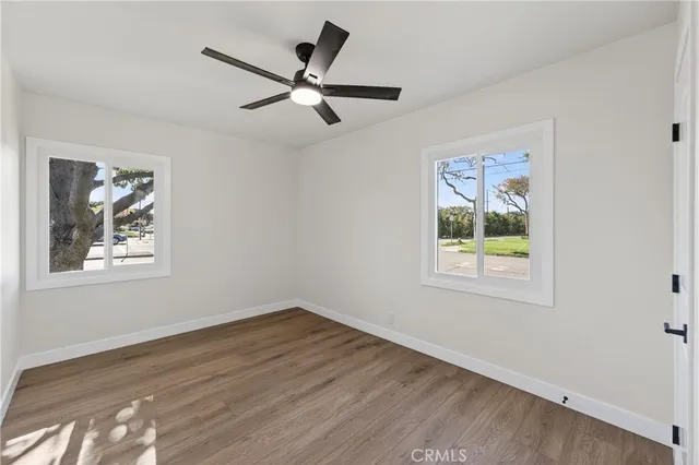 a view of a hallway with wooden floor and entryway