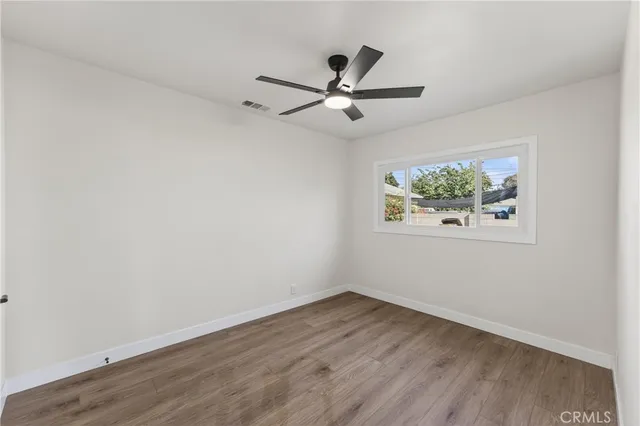 a view of an empty room and wooden floor