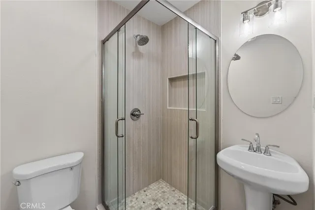 a bathroom with a sink toilet and shower