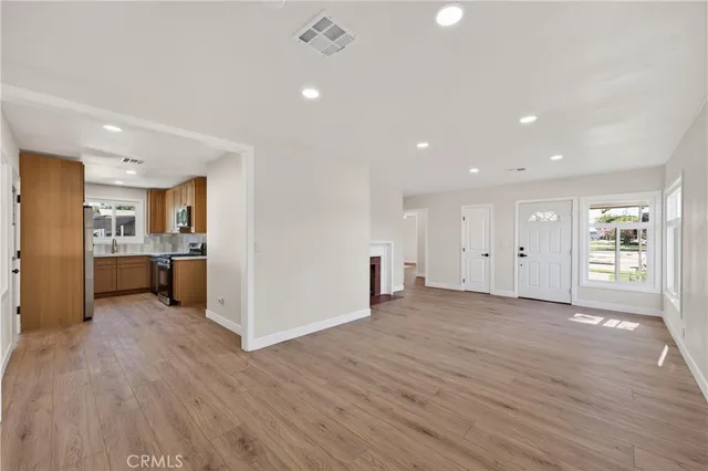 a view of a kitchen with wooden floor and a sink