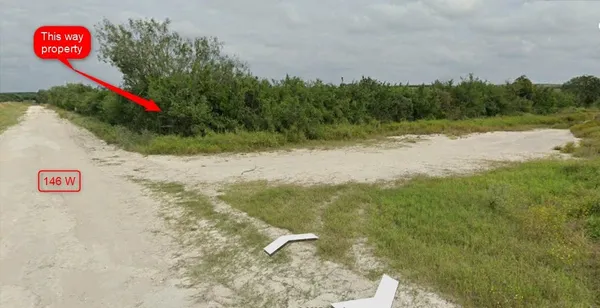 a view of a street with trees in the background