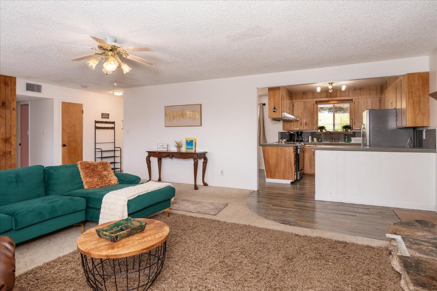 42324 Buckeye Road Oakhurst, CA 93644 - Photo 12 of 45 a living room with furniture and a chandelier