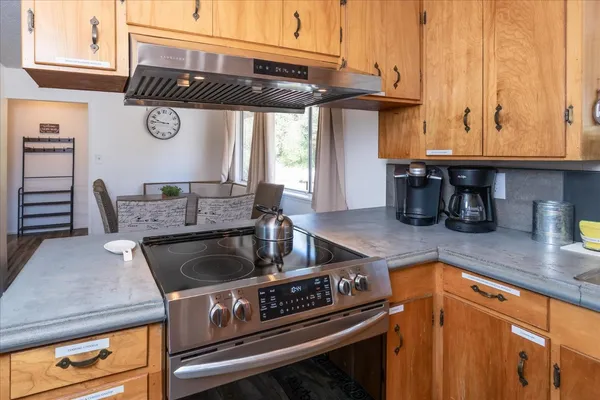 a kitchen with a stove and a white cabinets