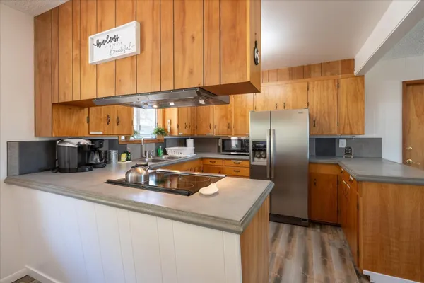 a kitchen with stainless steel appliances a sink and a refrigerator