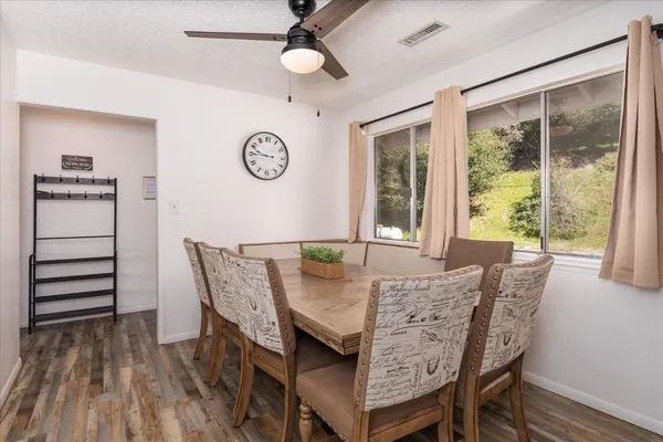 a view of a dining room with furniture window and wooden floor