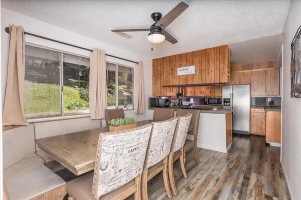 a living room with stainless steel appliances granite countertop furniture and a kitchen view