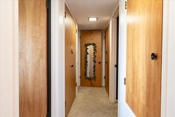 a view of a hallway with wooden shelves