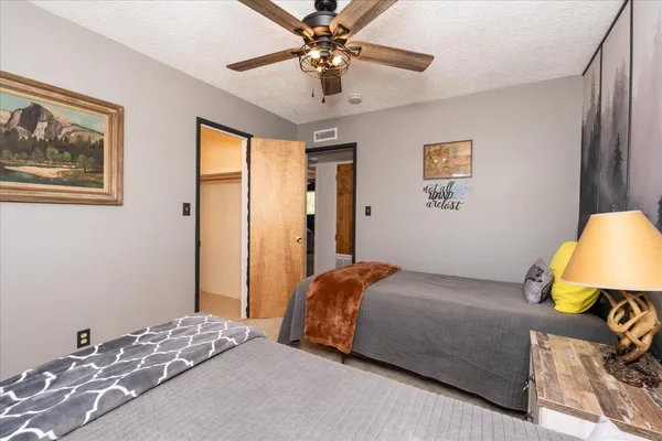 a bedroom with a bed and a chandelier