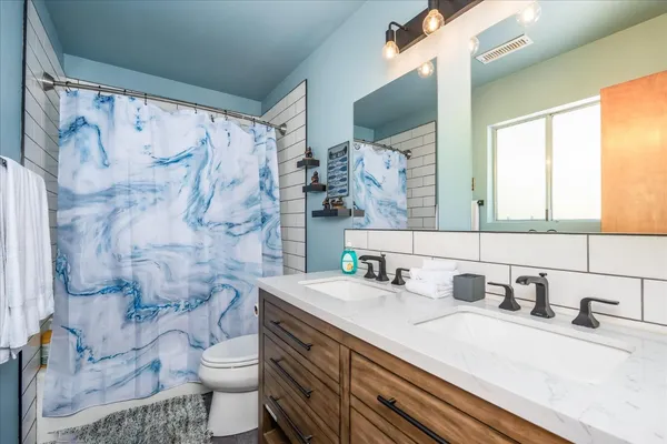 a bathroom with a sink toilet and shower