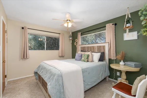 a bedroom with a bed and a window
