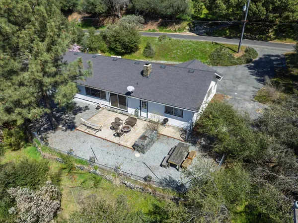 an aerial view of a house with a yard and lake view