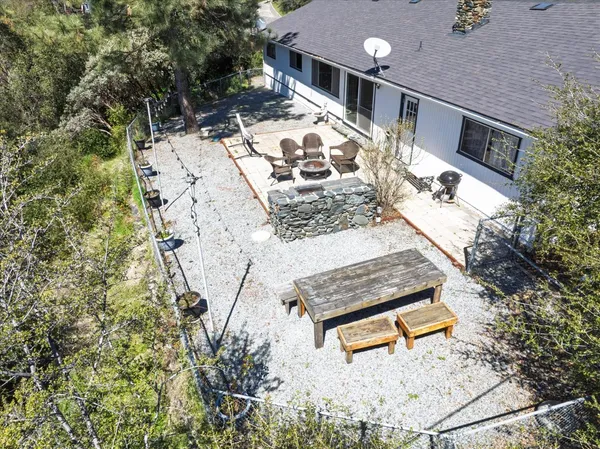 top view of a back yard of the house with a bench