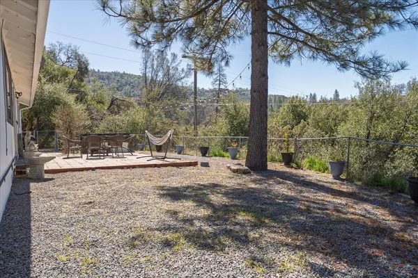 a view of a backyard with large trees