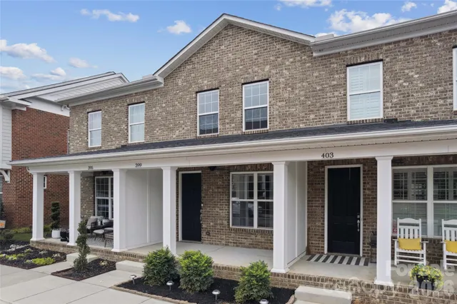 front view of a brick house with a large windows