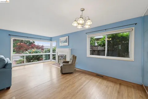 a view of a livingroom with furniture wooden floor and window