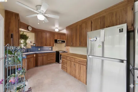 a kitchen with stainless steel appliances a refrigerator sink and cabinets