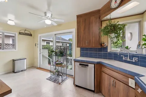 a kitchen that has a sink and chairs