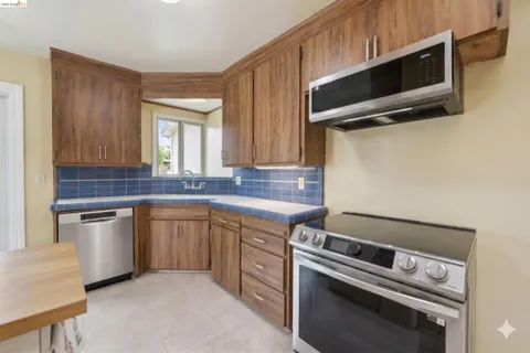 a kitchen with a sink stove and microwave