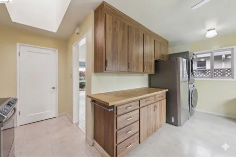 a kitchen with a stove refrigerator and a sink