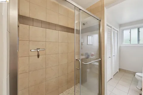 a bathroom with a glass shower door