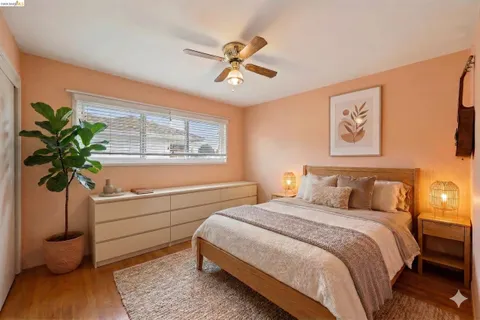 a bedroom with a bed and a potted plant