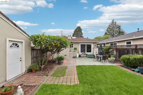 a view of a house with patio and garden