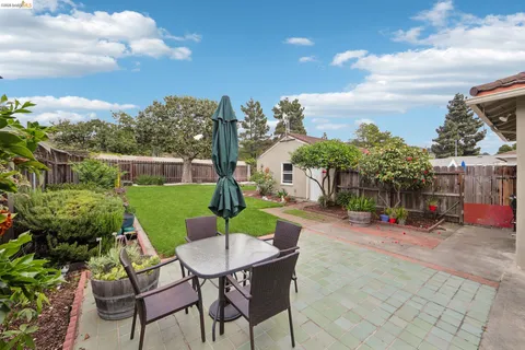 a view of a backyard with sitting area