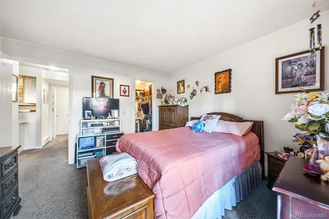 a bedroom with a bed and potted plants in it